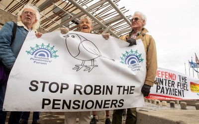 Stop Robin the Pensioners banner at the Scottish Parliament